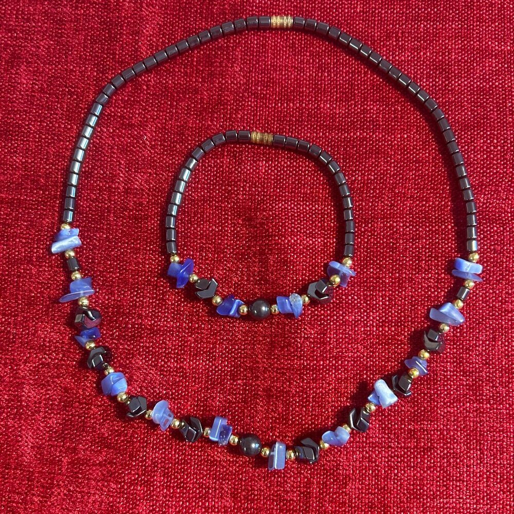 Necklace and bracelet set in metallic looking beads in blue and dark grey